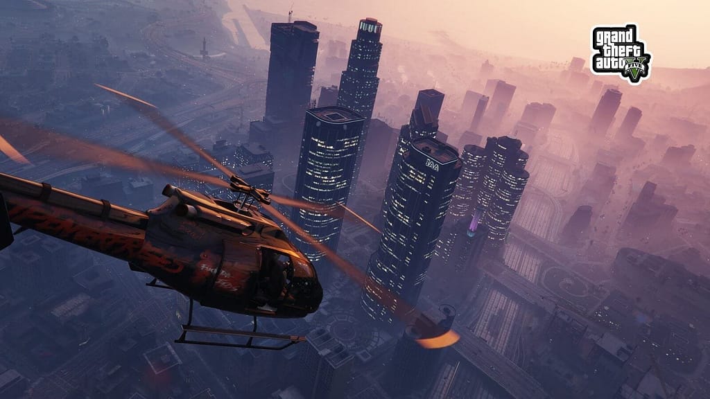 Free GTA V PC Upgrade Arrives March 4 GTA V Aerial View: Helicopter Flying Over the City Skyline at Sunset with a Dazzling Urban Landscape Below